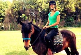 Volunteer Argentina An Equine Therapy volunteer in Argentina speaks to a child before starting a treatment session with her therapy horse.