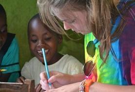 Volunteer Christmas A child watches a volunteer on a placement in Ghana