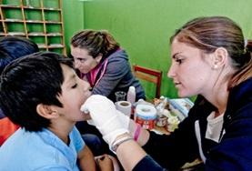 Volunteer Medical Electives A Dentistry Elective volunteer inspects a patient on a placement in Peru