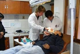 Volunteer Medicine & Healthcare Dentistry volunteers work on a patient at a placement in Peru