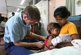 Volunteer Medicine & Healthcare A Medicine volunteer performs a general check-up on a young child during a healthcare screening in Sri Lanka.