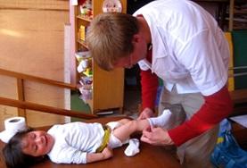 Volunteer Medicine & Healthcare A Nursing volunteer interacts with a child on a placement in Peru
