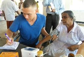 Volunteer Medicine & Healthcare A Nursing volunteer in Sri Lanka conducts basic health checks at a hospital, contributing to his medical experience during his internship.