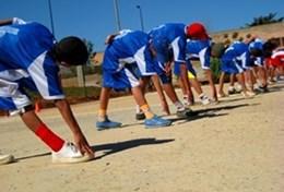 Volunteer Sports Young athletes stretch before a race on a running track at our volunteer Athletics placement in Sri Lanka.